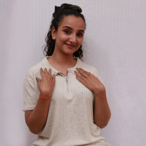 Woman wearing cream-colored hemp polo neck knitted t-shirt with zipper