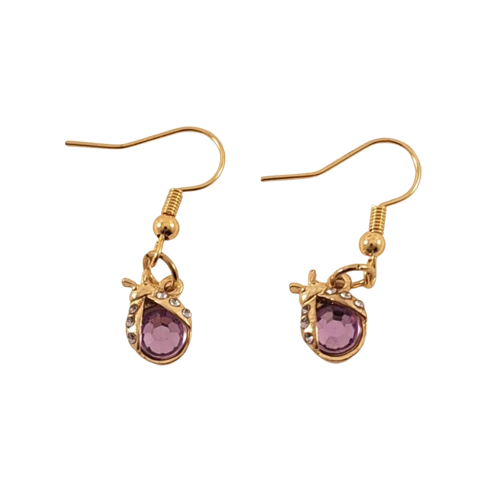 Pair of gold earrings with purple gemstones shaped like ladybugs