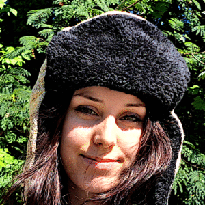 Woman wearing black fuzzy cap in natural light